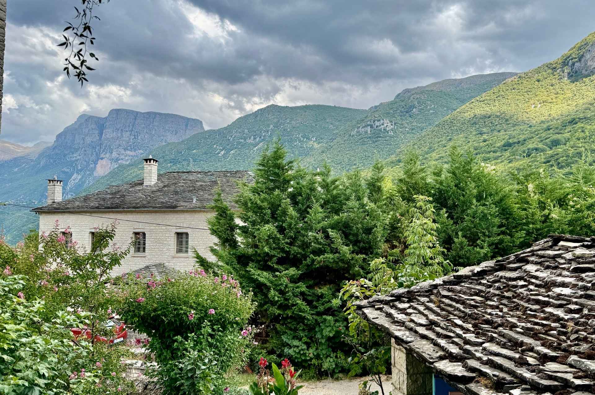 A grand stone mansion overlooking the verdant slopes of the Pindus National Park.